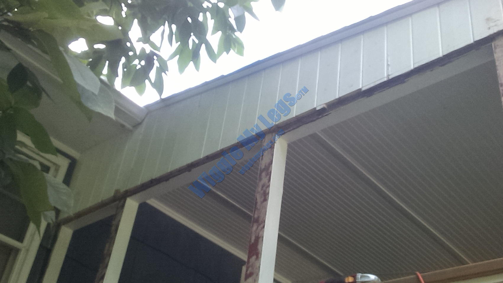 Same gable attempting to show some of wood rot and edge gaps in shiplap siding.