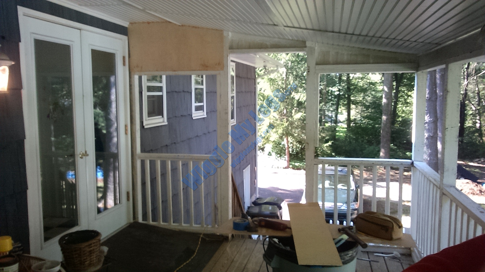 First plywood panel going up behind repaired shiplap hole.