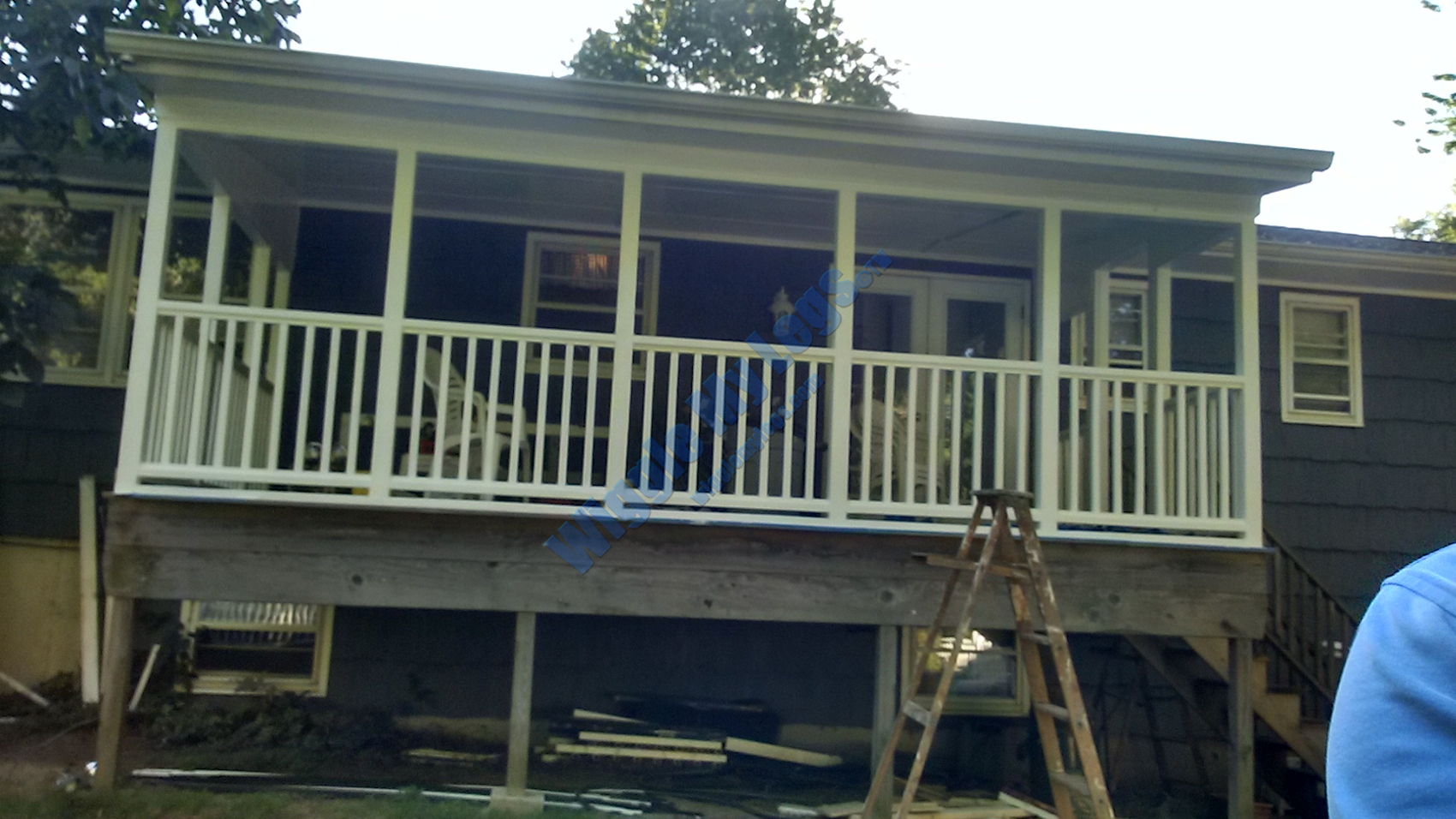 View from yard of deck after sanding, caulking, and painting.