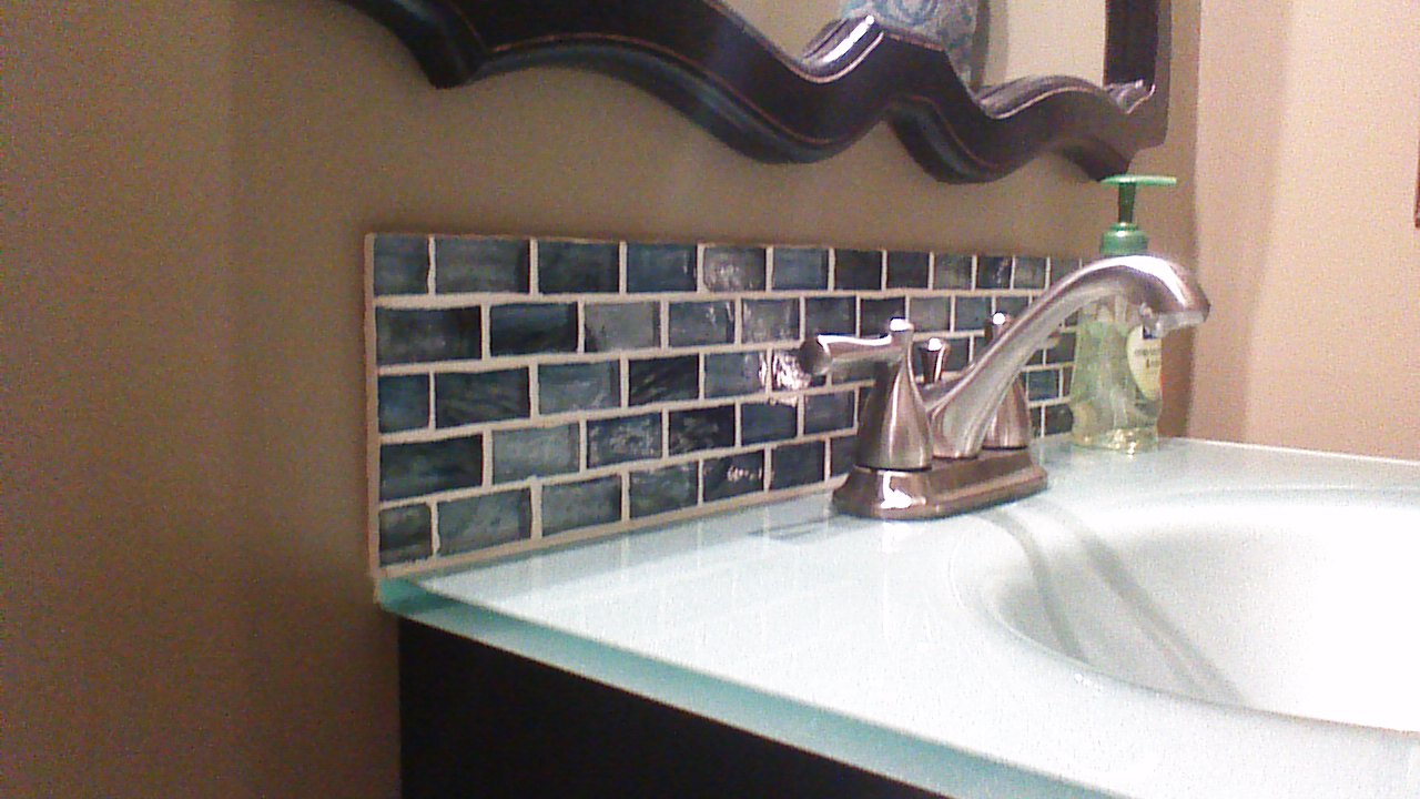 Close up photo of new glass tile backsplash.