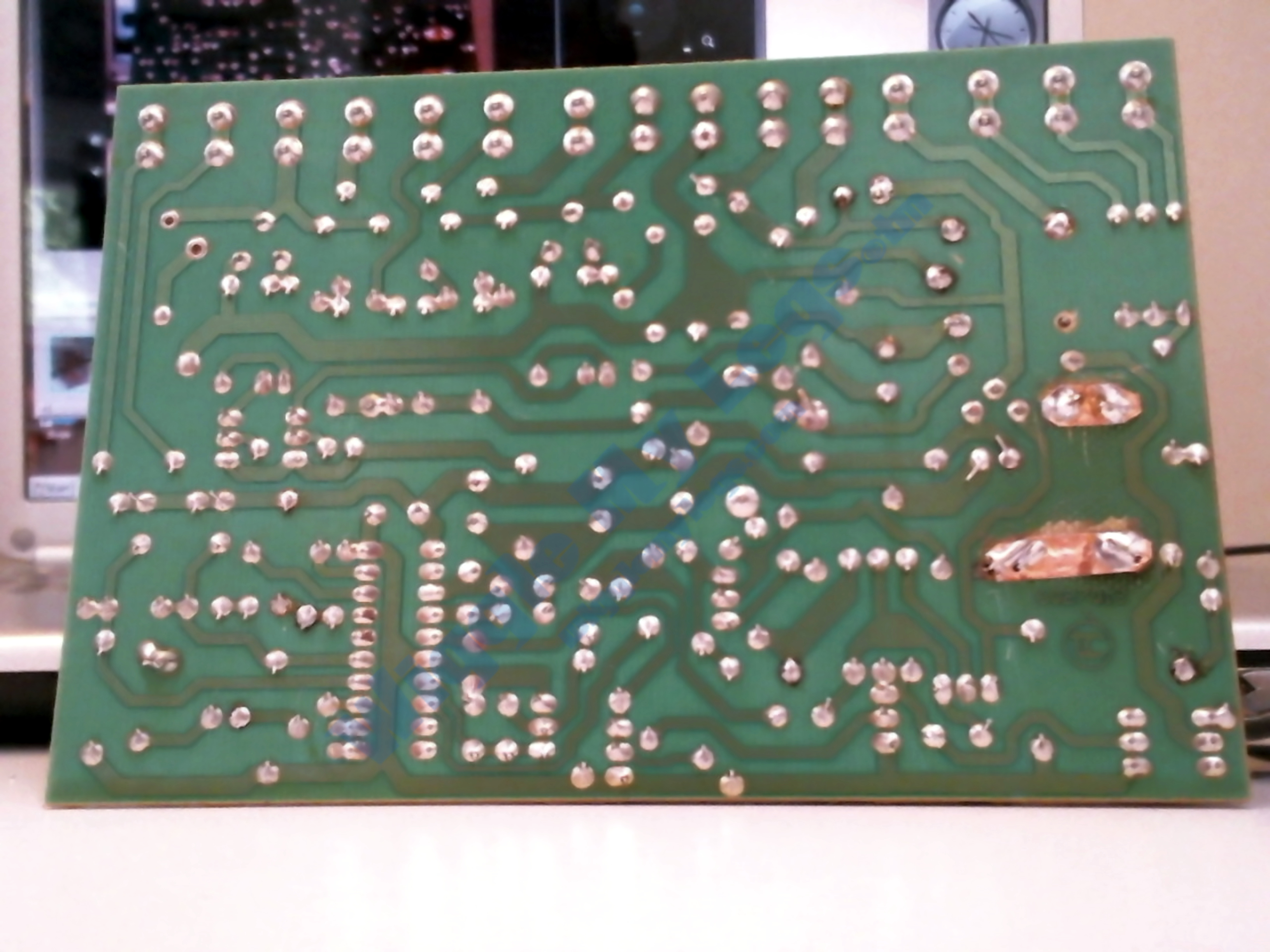 Photo of the solder side of repaired PCB.
